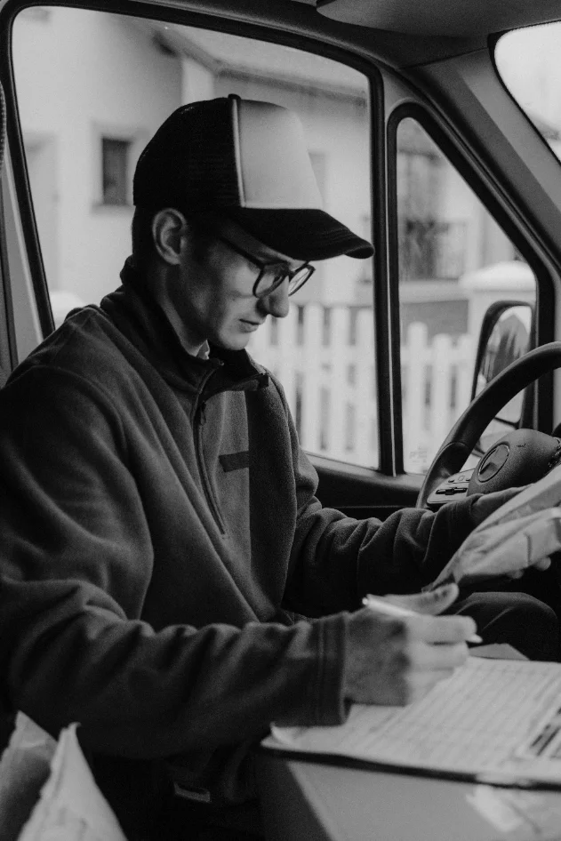 A driver holding a tablet at the loading rack